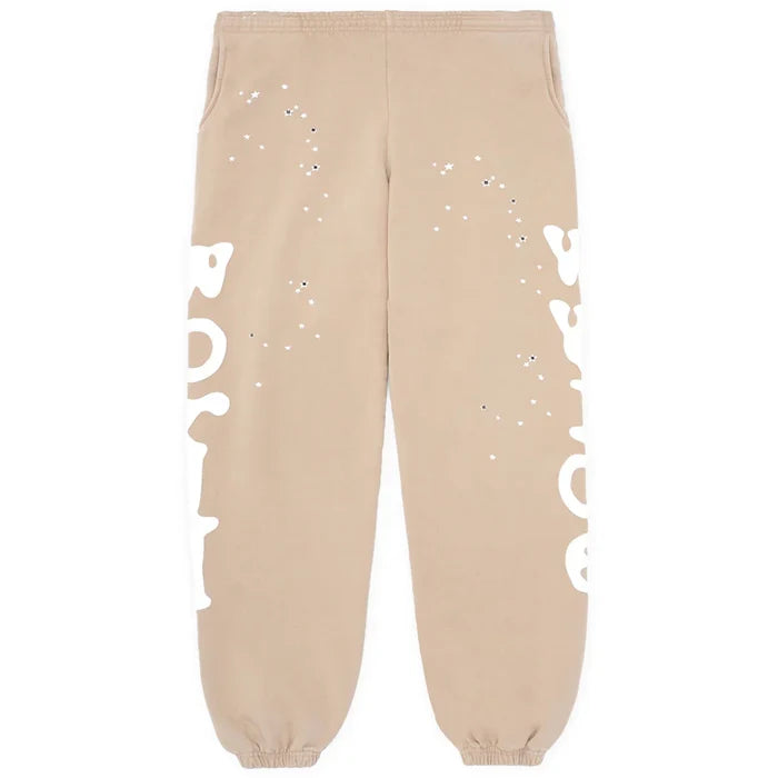 Beige 100% cotton Sp5der sweatpants for men, featuring a relaxed fit, elastic waistband and cuffs, side logo graphic, and streetwear-inspired style—perfect jogger pants for casual comfort.