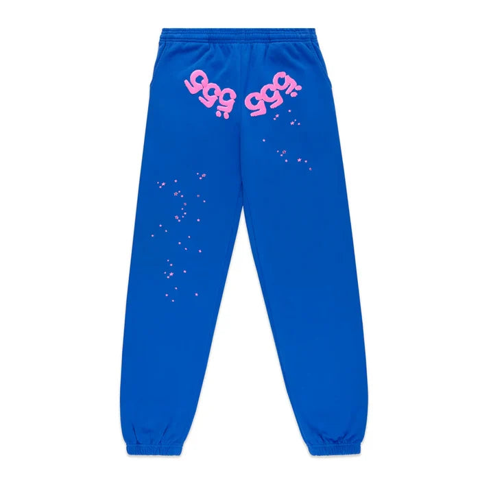 100% Cotton Sp5der Sweatpants – Unisex blue jogger pants with relaxed fit, elastic cuffs and waistband, pink logos near the pockets, and pink star accents—streetwear inspired by Sp5der style.