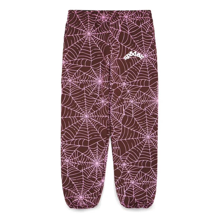 100% Cotton Sp5der Sweatpants – Unisex brown jogger pants with an all-over pink spider web print, small white logo, and a relaxed fit. Features elastic waistband and cuffs for comfort and streetwear style.