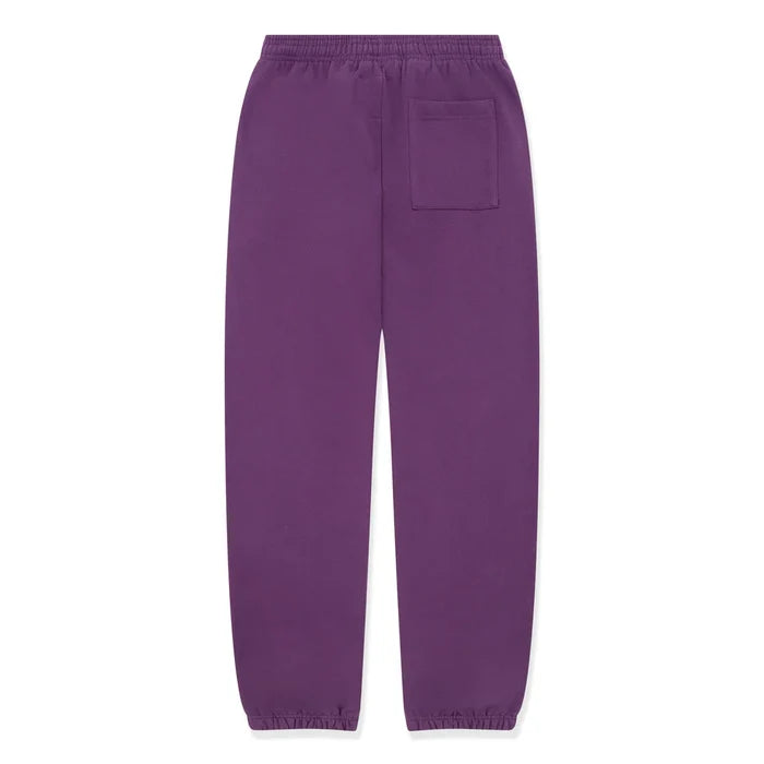 100% Cotton Sp5der Sweatpants – Unisex purple jogger pants with yellow logo and star graphics, featuring an elastic waistband, cuffs, and a single back patch pocket. Relaxed fit for simple, casual streetwear style.