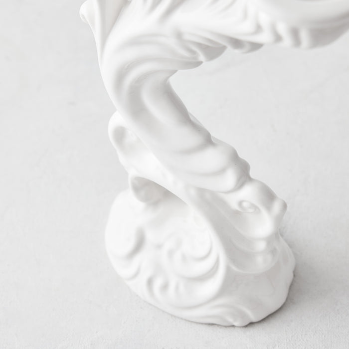 Assisi white ceramic candlestick with ornate, vintage-inspired sculptural detailing and a glossy glaze finish.