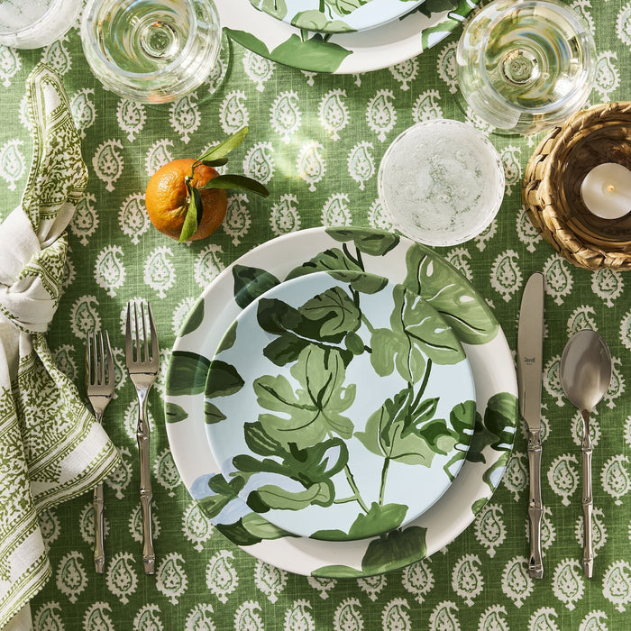 Bali 18/10 stainless steel 5-piece flatware set with bamboo-inspired texture on a green patterned table setting.