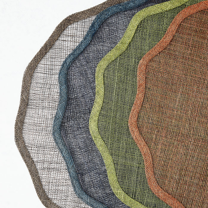 Set of five round, semi-transparent abaca fiber placemats with scalloped edges in assorted tonal colors.