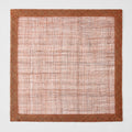 Square brick red abaca fiber placemat with a woven semi-transparent center and a solid textured border.