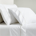 White percale sheet set with two pillowcases and a flat sheet, featuring brown diamond embroidered trim.