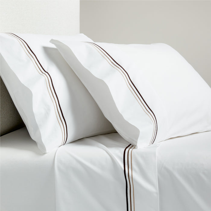 White percale sheet set with brown triple stitch edging on pillowcases and flat sheet.