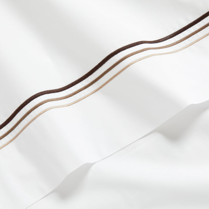 White percale sheet with brown and tan triple stitch edging.