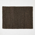 Chocolate brown rectangular placemat hand-woven from 100% abaca fiber, 19 by 14 inches.