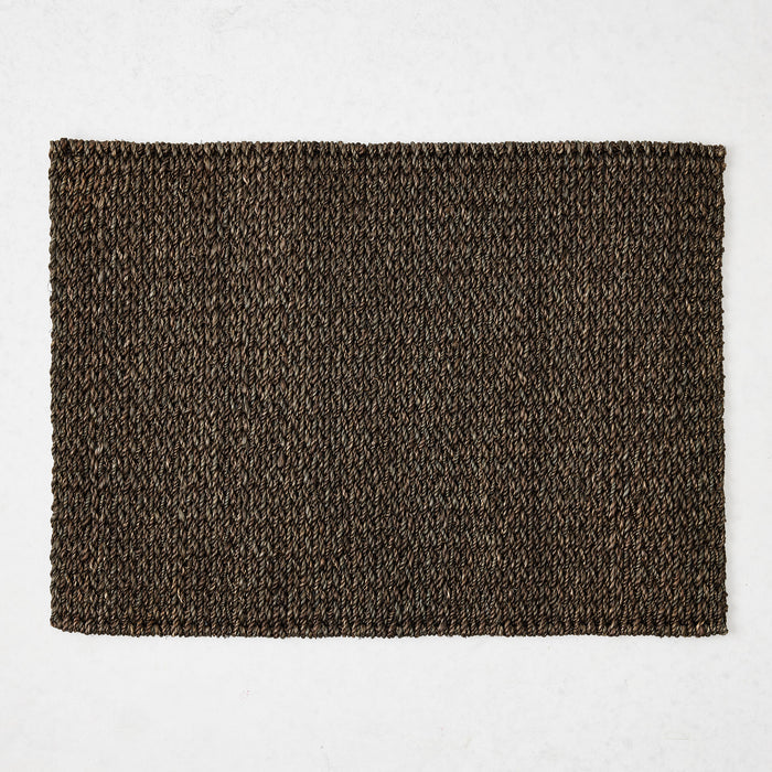 Chocolate brown rectangular placemat hand-woven from 100% abaca fiber, 19 by 14 inches.