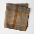 Chocolate brown and camel plaid linen napkin with a herringbone weave, 21-inch square.