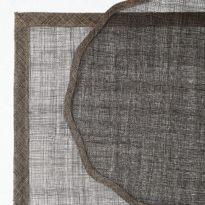 Chocolate brown round abaca fiber placemat with a scalloped edge and semi-transparent woven texture.
