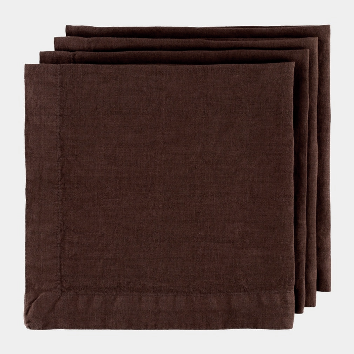 Stack of three folded Cocoa HG brown hand-dyed 22" linen napkins with mitered corners.