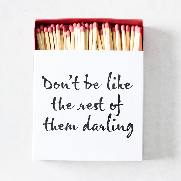 Oversized matchbox with white cover, black script text, and red-tipped 4-inch wooden matches inside.