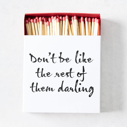 Oversized matchbox with white cover, black script text, and red-tipped 4-inch wooden matches inside.