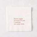 White 5.5-inch square 3-ply paper cocktail napkin with brown text reading Each night around 10 pm I realize it’s only 5:30.