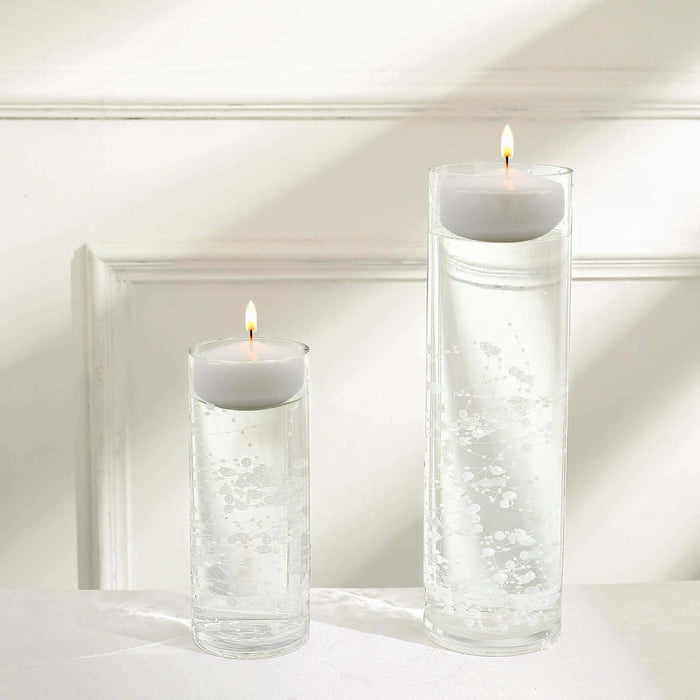 Floating candles in clear glass vases filled with water