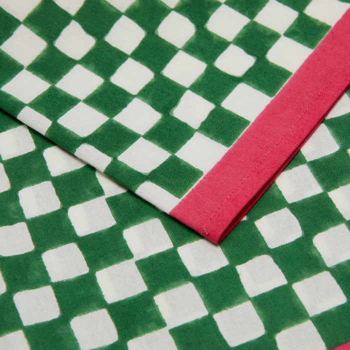 Green and white check cotton voile napkin with a pink border.