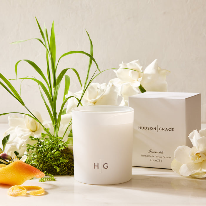 Hudson Grace Greenwich Scented Candle in a white frosted glass jar with HG logo, next to its white box.