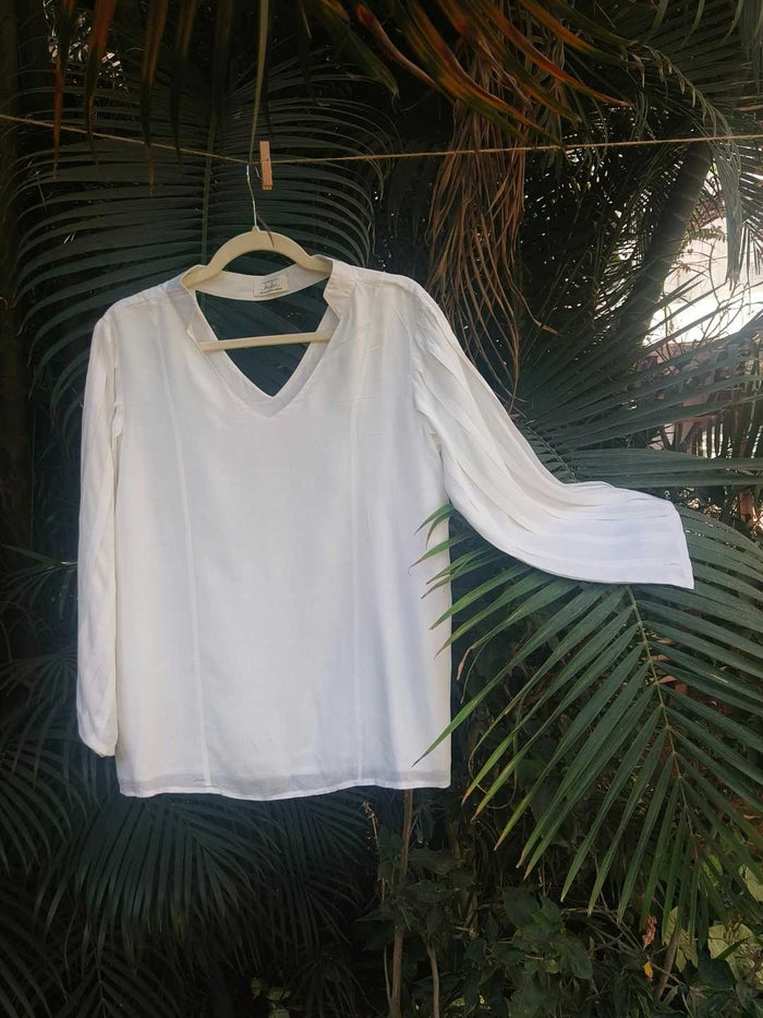 Ivora Top- White Flared Sleeve Top in 100% Tencel | Jhultaru. 100% Tencel- silky smooth, biodegradable, eco-friendly and sustainable- Ivora is a consciously crafted blouse in 100% Tencel featuring pleated flare sleeves and a soft drape. Lightweight, breathable, and sustainably made at Jhultaru.