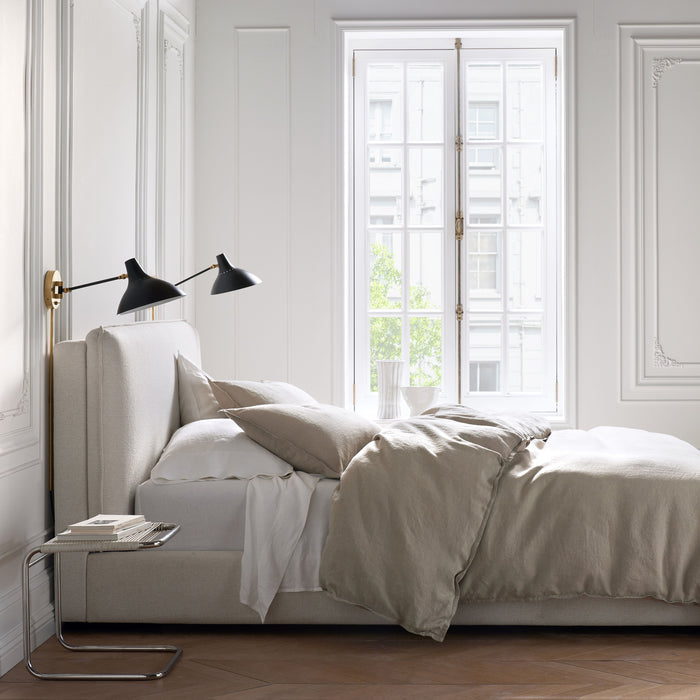 Khaki Washed-Linen Pillowcases on a bed with matching duvet, white sheets, and light-colored headboard.