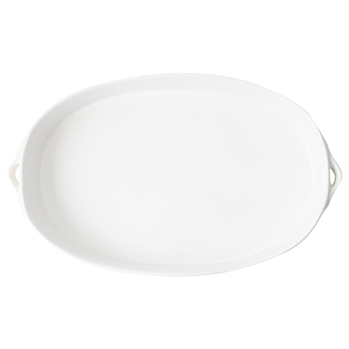 Large oval white stoneware baker with small side handles, 15.4-inch length, minimalist design for oven-to-table serving.