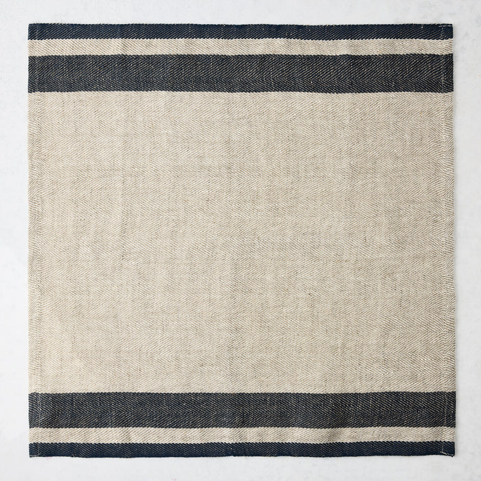 Lexington Blue Stripe Border Napkin, natural linen-cotton blend with navy blue stripes on edges.