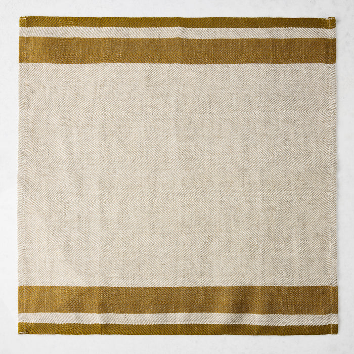 Lexington Gold Stripe Border Napkin, natural linen-cotton blend with gold stripes on edges.