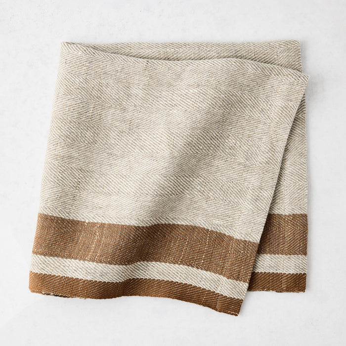 Lexington Tobacco Brown Stripe Border Napkin, linen-cotton blend, natural with brown stripes.