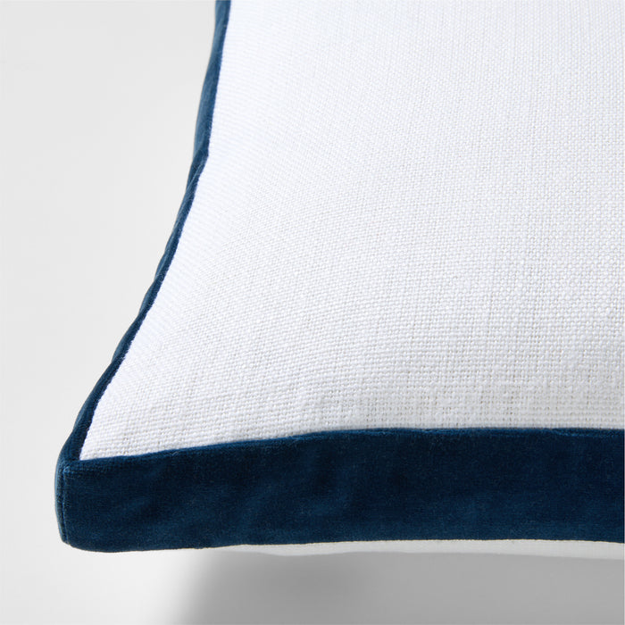 White linen lumbar pillow with midnight blue velvet gusset trim.