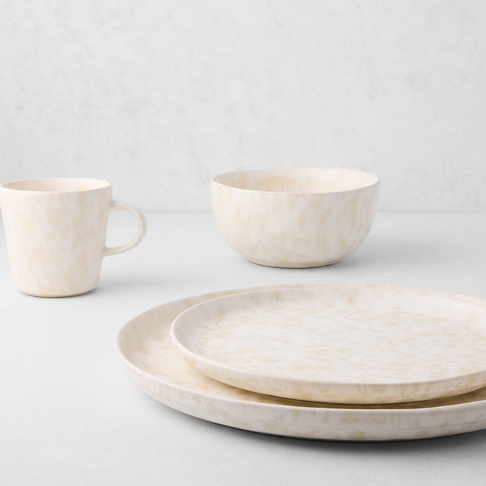 Natural Nuno Splatter stoneware salad plate with beige spots on a pale cream base.