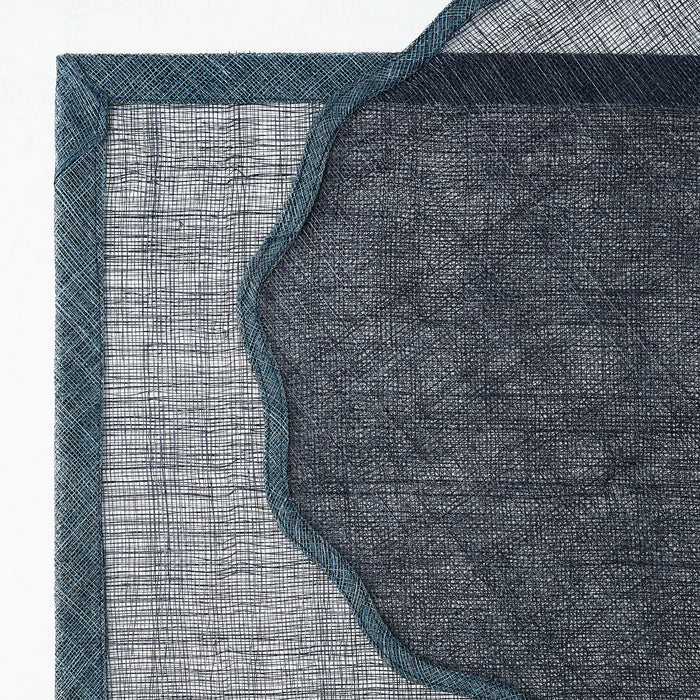 Navy blue tonal Newport scalloped placemat made of semi-transparent woven abaca fibers with a solid border.