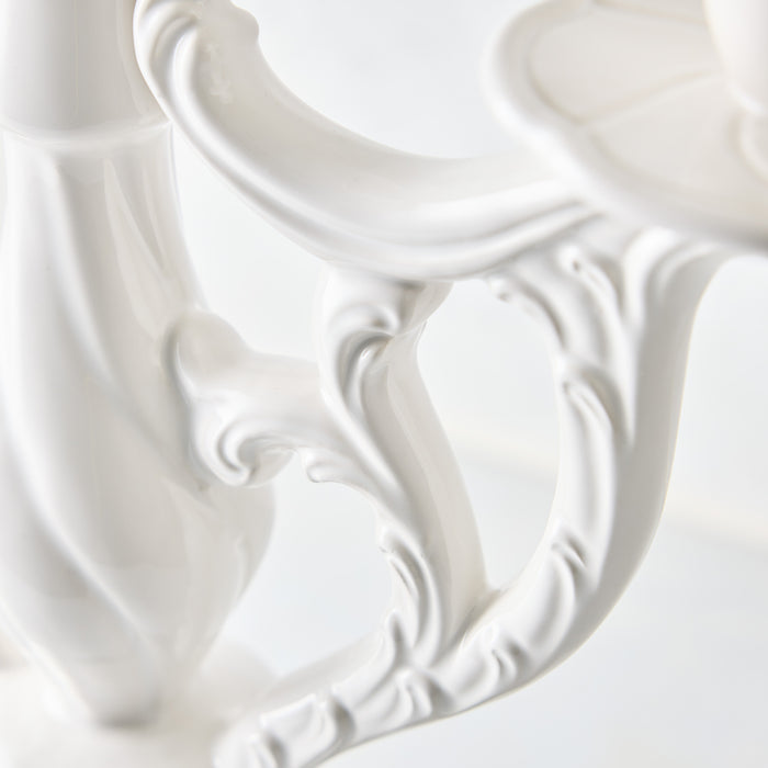 Orvieto white ceramic candelabra with ornate, vintage-inspired scrollwork and a glossy glazed finish.