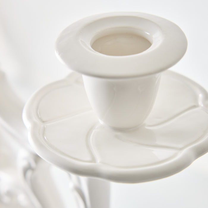Orvieto white ceramic candelabra with a glossy glaze finish and a scalloped, petal-inspired base design.
