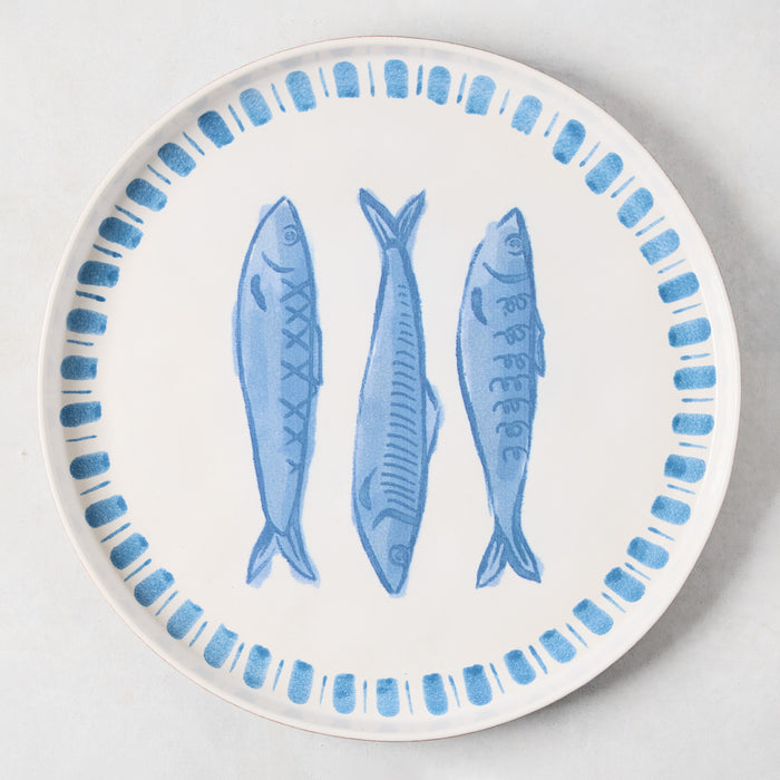 White terracotta round serving platter with three hand-painted blue sardines and a blue border.