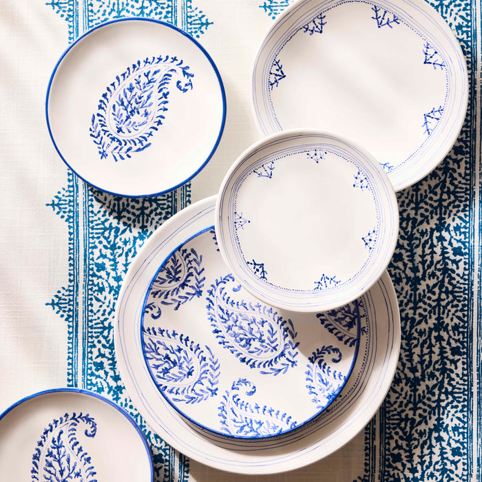 Peter Dunham + Hudson Grace Blue Hand-Painted Kashmir Paisley Appetizer Plates on a patterned tablecloth.