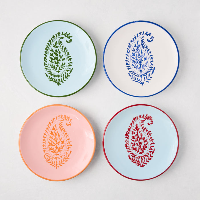 Four hand-painted appetizer plates with Kashmir paisley designs in blue, green, orange, and red.