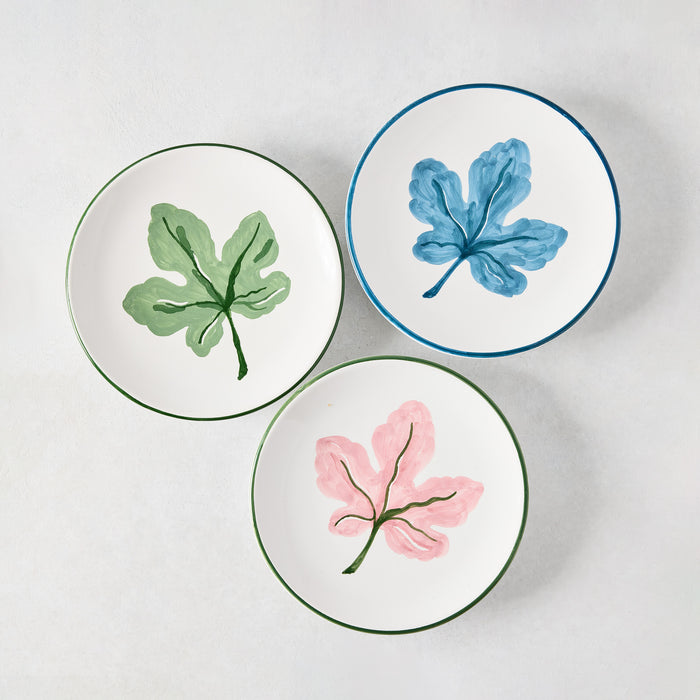 Three Peter Dunham + Hudson Grace hand-painted appetizer plates: green, blue, and pink fig leaf designs.