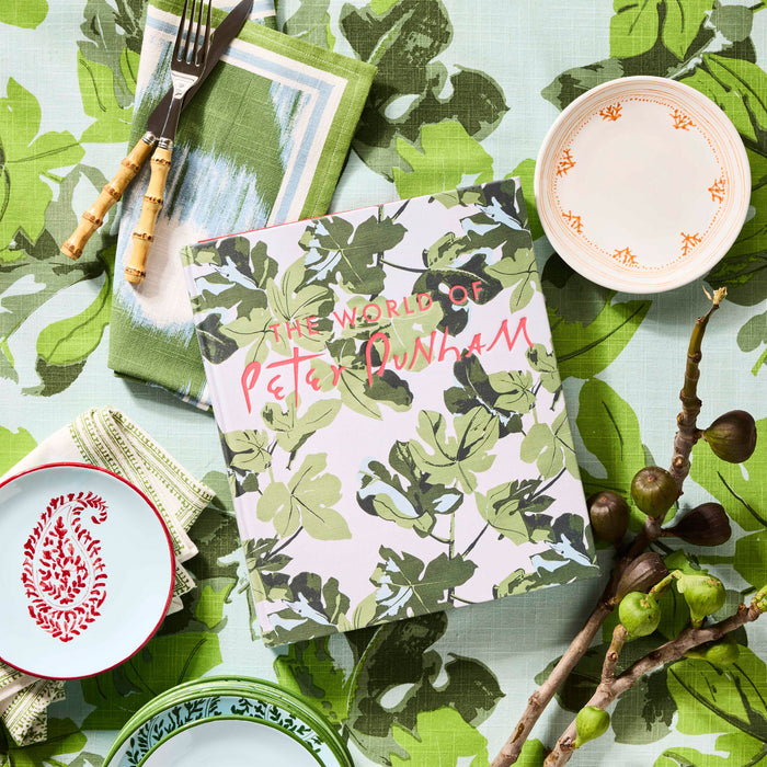 Peter Dunham + Hudson Grace Orange Fez Appetizer Plate with hand-painted border, shown with other tableware.