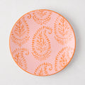 Pink Kashmir hand-painted paisley salad plate with orange design and rim.