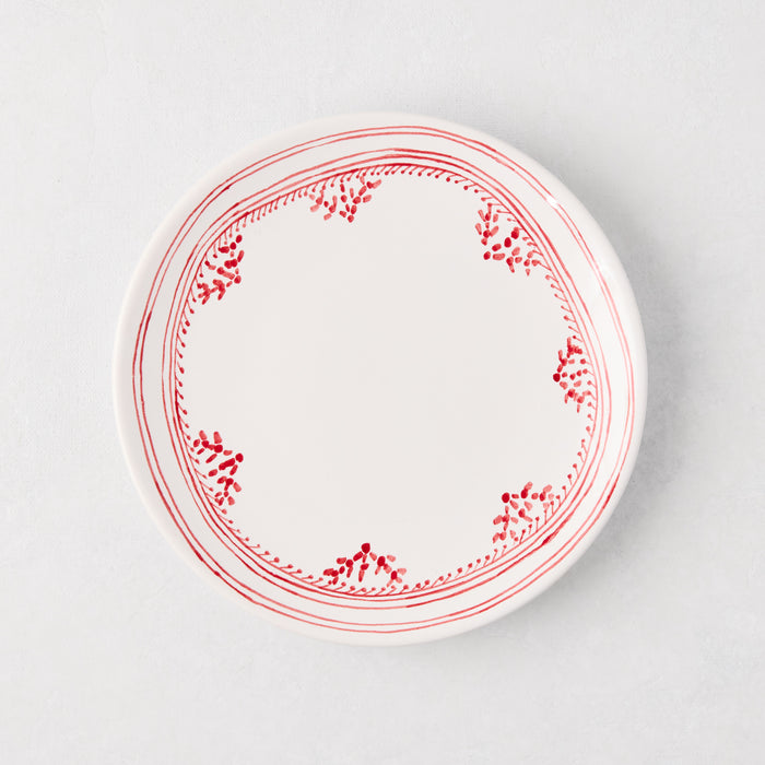 White appetizer plate with a hand-painted red fez border pattern.