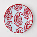 Peter Dunham + Hudson Grace Red Kashmir hand-painted paisley salad plate on light blue.