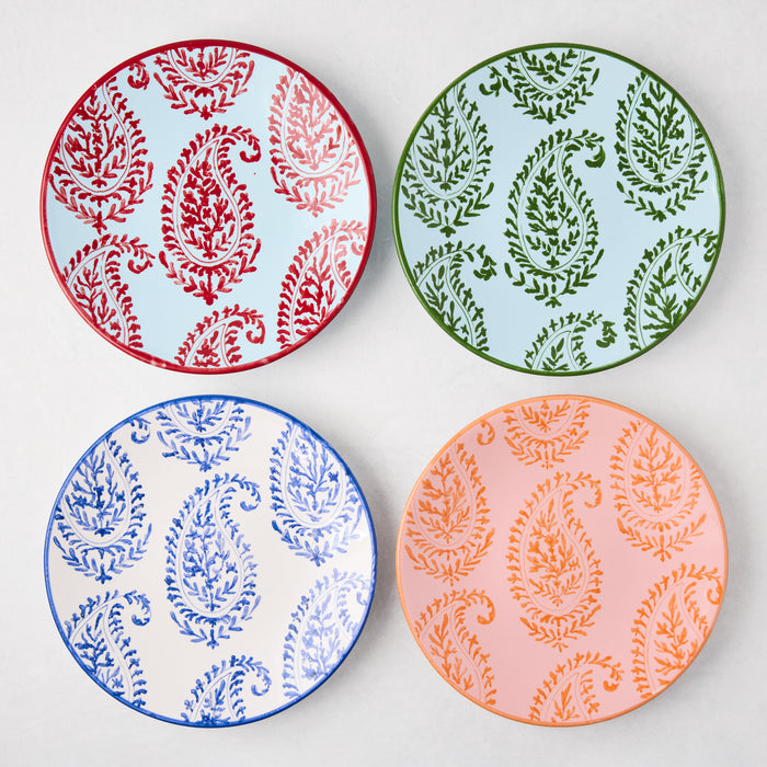 Four Peter Dunham + Hudson Grace Kashmir hand-painted paisley salad plates in red, green, blue, and orange.