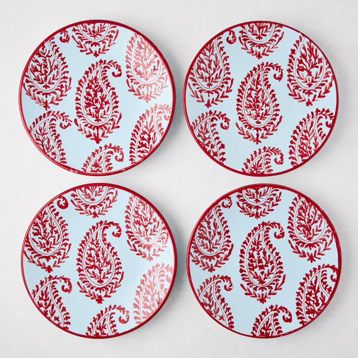 Four Peter Dunham + Hudson Grace Red Kashmir hand-painted paisley salad plates with light blue background.