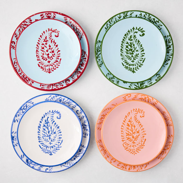 Four hand-painted Peter Dunham + Hudson Grace paisley salad plates in red, green, blue, and orange designs.