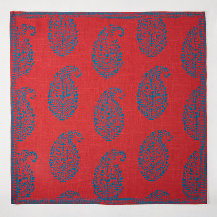Red Kashmir Paisley Printed Napkin by Peter Dunham + Hudson Grace, featuring blue paisley pattern and border.