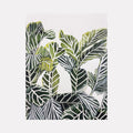 The artwork 'Plant Life II' by Rachel Kohn features a striking botanical watercolor illustration of overlapping tropical leaves in various shades of green and gray. The detailed linework in ink highlights the intricate vein patterns of each leaf, creating a layered, geometric composition against a white background. The contemporary botanical style combines precise detail with artistic fluidity.