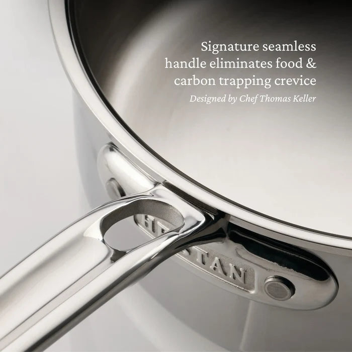 Close-up of a ProBond Luxe® Polished Clad Stainless Steel Saucier Pan, 2-Quart, highlighting its seamless handle. Text on the pan emphasizes how the professional clad stainless steel construction eliminates food and carbon-trapping crevices—an innovative design feature inspired by Chef Thomas Keller.