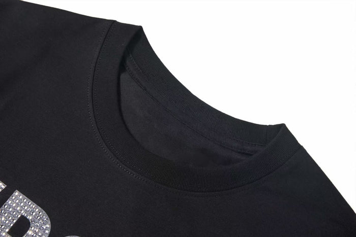 Black crew neck streetwear T-shirt with crystal rhinestone graphic detail on the chest and ribbed collar