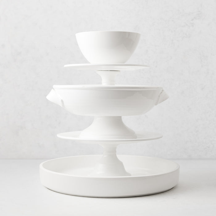 Three-tiered white ceramic serving stand with a round base and glossy glaze finish.