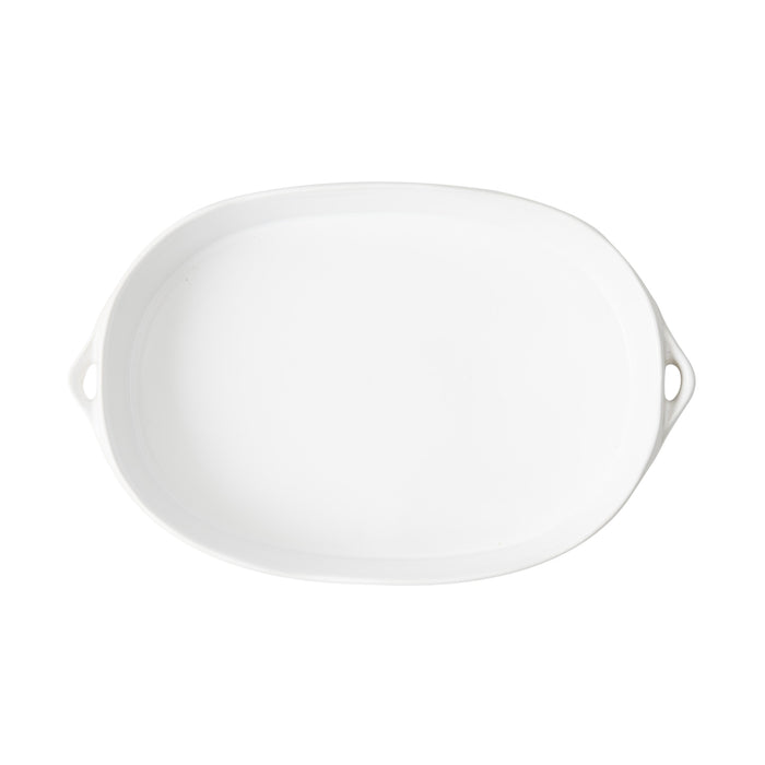 Small white oval stoneware baker with side handles, 11.6-inch oven-safe serving dish with a smooth glazed finish.